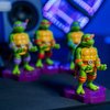 Exquisite Gaming: Holdems: TMNT - Michaelangelo - Earbud & Phone Holder, Cable Guys, Mini Collectibles with a Twist, Teenage Mutant Ninja Turtles Figure