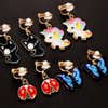 A chic set of 20 pairs clip on earrings for girls without Pierced Ears,Vibrant Themes Like Flowers, Unicorns, Ladybugs, Butterflies, Sheep