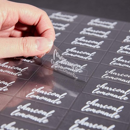 Restaurantware Label Tek 1.9 x 1 Inch Charcoal Lemonade Juice Bottle Labels 100 Water-Resistant Labels For Bottles - Self-Adhesive Clear With White Font Plastic Bottle Stickers For Drink Pouches