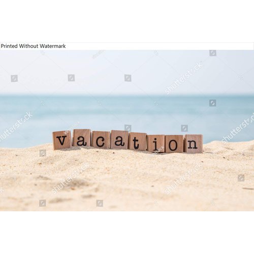 Poster Reproduction of Vacation word on wood rubber stamps stack on the sand beach for holiday and summer season concepts, beautiful blue ocean view during daytime on a sunny day on background